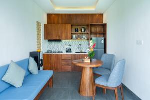 a living room with a blue couch and a table at Alam Dana Ubud in Ubud