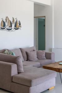 a living room with a couch and a table at Aegean colors Tinos in Tinos