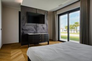 a bedroom with a bed and a television on a wall at Altavista Roero in Monteu Roero +64 photos