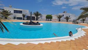 two people in a swimming pool in a resort at Marina azul in Puerto Calero