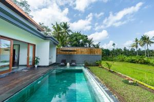 a swimming pool in the backyard of a villa at Alam Dana Ubud in Ubud