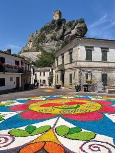 a colorful mural on the side of a street at La Ginestra in Roccascalegna