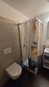 a bathroom with a toilet and a shower with a shower curtain at The Golden Secret Court in Venice +51 photos