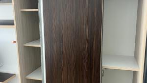 a closet with a wooden door and some shelves at Cazare Mangalia - Self Check-in in Mangalia