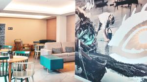 a waiting room with a couch and tables and a painting at Agua Hotels Alvor Jardim in Alvor +23 photos