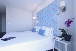 Кровать или кровати в номере Agua Hotels Alvor Jardim +24 фотографии