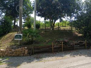 a garden with a sign and flowers in a park at Rive rosse in Masserano