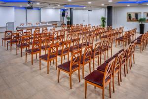 a row of wooden chairs in a room with a screen at 4R Gran Regina in Salou +38 photos