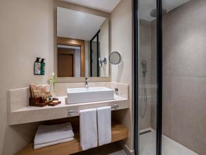 a bathroom with a sink and a shower at Rixos Premium Tekirova - The Land of Legends Access in Tekirova