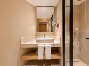 a bathroom with a sink and a shower at Rixos Premium Tekirova - The Land of Legends Access in Tekirova