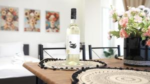 a bottle of wine sitting on top of a table at Central C3 studio in Volos