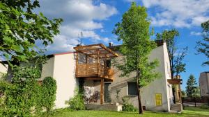 a house with a deck on the side of it at Apartamenty Ponidzie in Busko-Zdrój