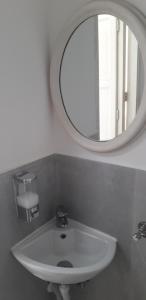 a bathroom with a white sink and a mirror at A Casa Di Alex in Catania