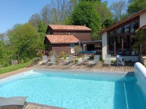 a swimming pool in front of a house at La caronnière in Mervent +14 photos