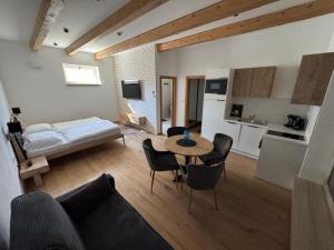 a living room with a bed and a table and chairs at Hotel Brick House Apartments in Nitra