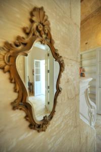 a mirror on a wall in a room at Sumptuous townhouse with roof terrace AGAL1-1 in Birgu +37 photos