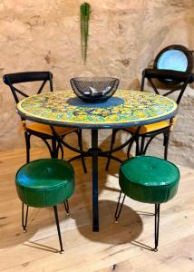 a table with two green chairs and a bowl on it at Il Rivellino - Tamerò Estates in Casperia +24 photos
