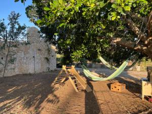 a hammock under a tree in a yard at West Pool House in Kineta