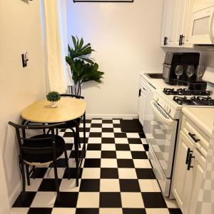 a kitchen with a black and white checkered floor at Welcome to New Rochelle Studio in New Rochelle