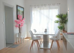 a dining room with a table and chairs and a window at La Miranda Dijon in Dijon
