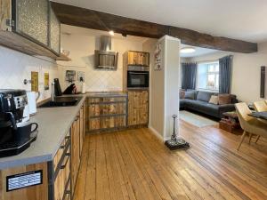 a kitchen and living room with a couch at Zum-Goldenen-Schaf in Blankenheim