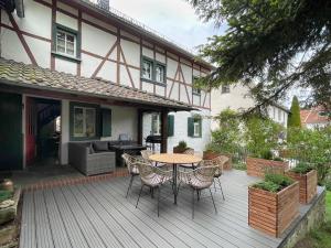 a wooden deck with a table and chairs in front of a house at Zum-Goldenen-Schaf in Blankenheim