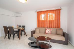 a living room with a couch and a table at Irene Luxury Apartments in Metaxáta