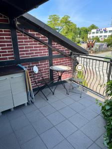 a balcony with a table and a brick building at 2 pokojowy apartament in Dąbki