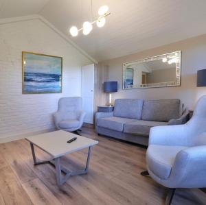 a living room with a couch and a table at Newly Refurbished Self-Catering Lodge Sleeping 5 in Wexford