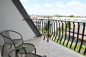 a balcony with chairs and a view of a street at Gate 11 in Otopeni