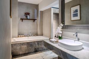 a bathroom with a tub and a sink and a bath tub at NH Collection Samui Peace Resort in Bophut  +37 photos