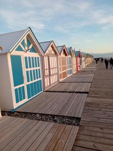 a row of beach huts on a boardwalk at Le Nid Marin, Cayeux-sur-Mer, Baie de Somme in Cayeux-sur-Mer +16 photos