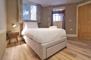 a bedroom with a large white bed and a window at Newly Refurbished Self-Catering Lodge Sleeping 5 in Wexford