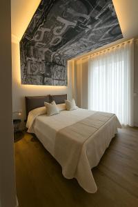 a bedroom with a large bed with a painting on the ceiling at Case Vacanze 106 Maison De Charme in Giovinazzo