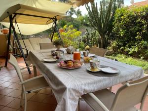 a white table with a plate of fruit on it at Mirbea in Cisano sul Neva