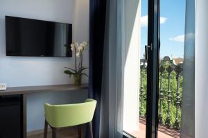 a yellow chair sitting in front of a window at Chi in Barcelona