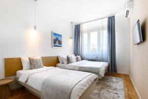 a hotel room with two beds and a window at Belgrade CITY CENTER Apartments PARKING 12e - 7 min by walk TERAZIJE in Belgrade +45 photos