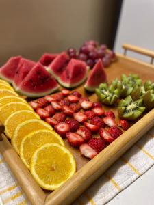 una tabla de cortar de madera con fruta sobre una mesa en HOSTEL Terra Branca, en Praia 9 fotos más