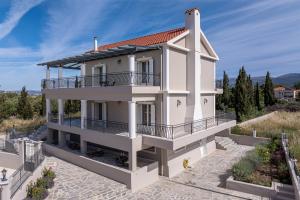 a villa with a view of a house at Irene Luxury Apartments in Metaxáta