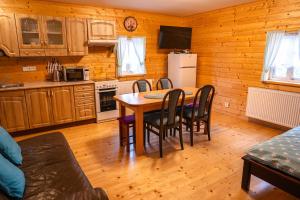 a kitchen with a table and chairs in a room at Chata Říp II  +17 photos