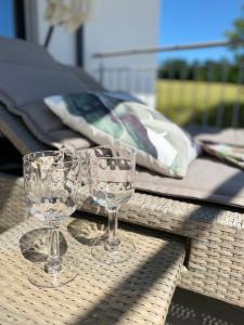 two wine glasses sitting on top of a table at Moderne Ferienwohnung Nähe Bad Griesbach, Haarbach in Haarbach