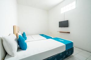 Postel nebo postele na pokoji v ubytování Rehat At Paskal Pelangi