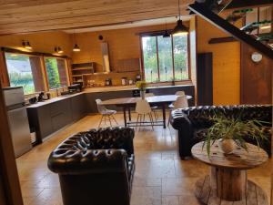 a kitchen and living room with couches and a table at L'atelier in La Rochefoulques