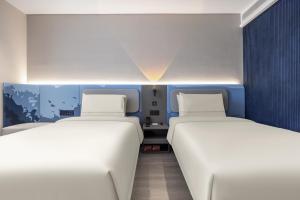 Ένα ή περισσότερα κρεβάτια σε δωμάτιο στο Atour Light Hotel Shandong University Central Campus