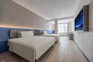 Ένα ή περισσότερα κρεβάτια σε δωμάτιο στο Atour Light Hotel Shandong University Central Campus