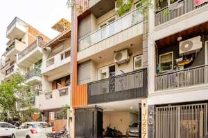 a tall building with cars parked in front of it at Divine India Service Apartment,Studio,J-267 Saket in Jāmb