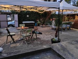a patio with a table and chairs and an umbrella at Вила Радеви in Obzor