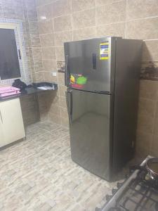 a stainless steel refrigerator in a kitchen at استيلا هايتس الساحل الشمالي in Dawwār ‘Abd al Qādir Qāsim