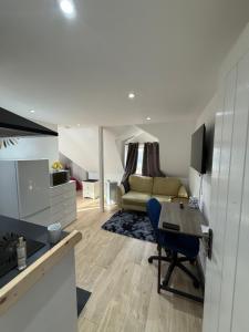 a living room with a table and a couch at A Lovely and Cosy Studio Apartment in Navestock