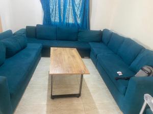 a blue couch with a coffee table in a living room at استيلا هايتس الساحل الشمالي in Dawwār ‘Abd al Qādir Qāsim +1 photo